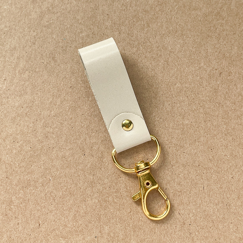 Porte-clé beige lustré - or