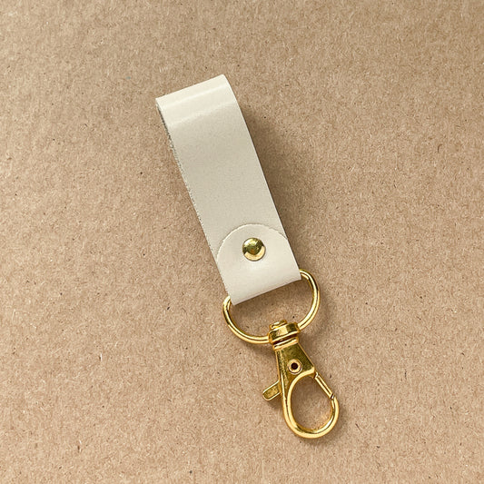 Porte-clé beige lustré - or